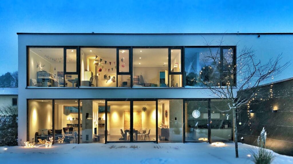 Modern house with floor-to-ceiling windows in wintertime